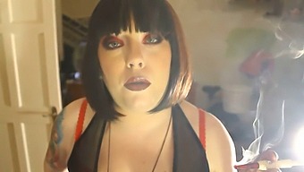 Domme Tina Smua Smokes A Filterless Cigarette With A Holder