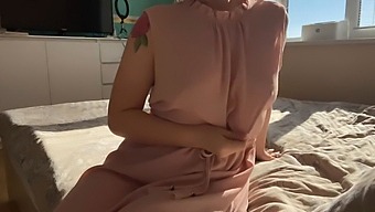 A Woman In A Delicate Pink Dress Explores Her Sensual Desires